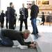 Czarnowski employee Kevin Schultz, reattaches a portion of a stage flooring at the North American International Auto Show during the press preview on Monday, Jan. 14, at Cobo Center in Detroit.   Melanie Maxwell I AnnArbor.com